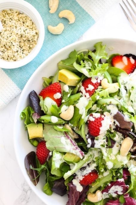 Strawberry Avocado Salad with Hemp Tahini Dressing - A bright and sunny salad for summer, loaded with superfoods and tossed in a creamy, dairy-free tahini hemp dressing. Pair it with your protein of choice for a complete meal. Recipe via Eat Spin Run Repeat // @eatspinrunrpt