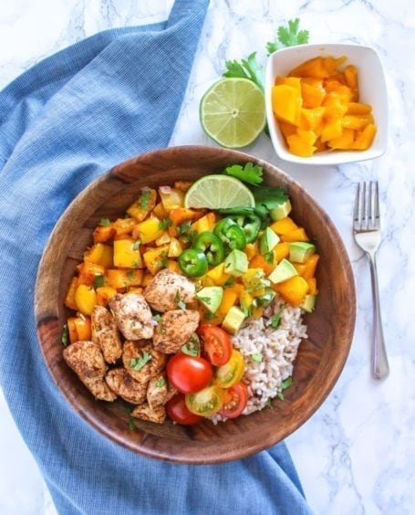 Zesty, spicy, sweet and super fresh, these Mango Jerk Chicken Bowls might soon become a healthy dinner time favourite. Serve with rice, or cauliflower rice to make it paleo-friendly. || Eat Spin Run Repeat