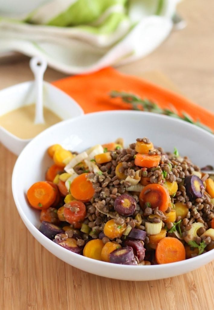 This Rosemary Rainbow Carrot and Lentil Salad is a perfect way to showcase some of fall's best produce! Lentils provide plant-based protein and iron, making this dish satisfying and packed with nutrition benefits. #vegan #vegetarian #lentils #thanksgiving
